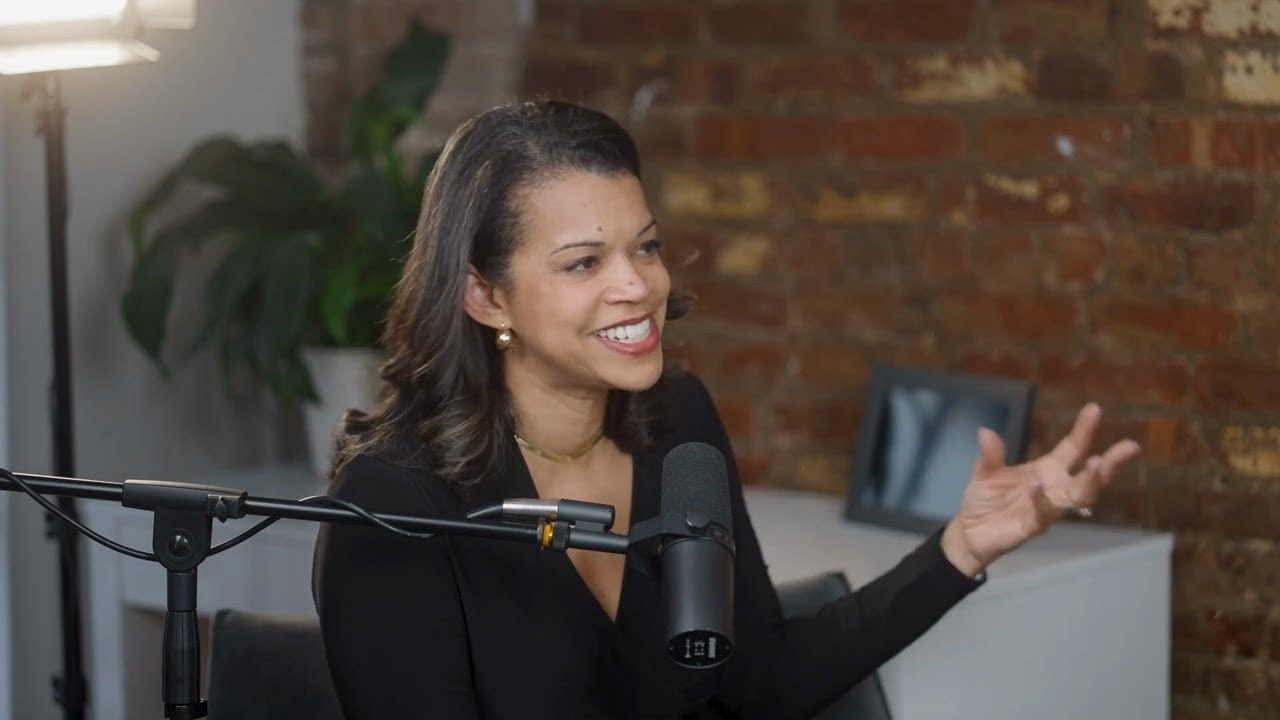 Dr. Shairi Turner speaking and gesturing during a podcast recording